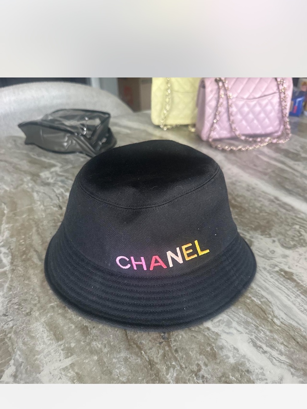 CHANEL Black Bucket Hat with Pink-to-Yellow Gradient Logo